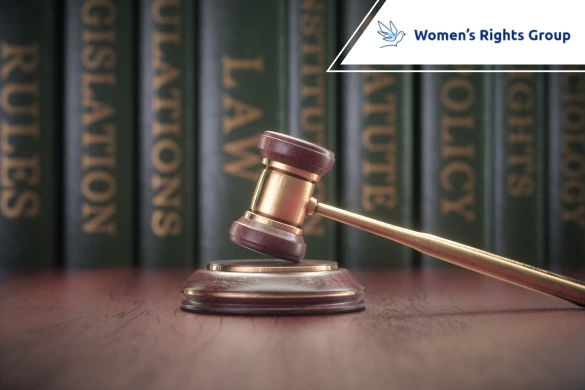 Gavel resting on a stand with law books in the background